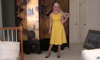 Busty blonde milf Rebecca Nollan slides out of her yellow dress and rubs her nyloned pussy