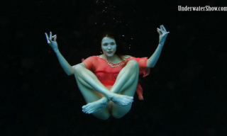 Adriana shows her tits and pussy swimming like a mermaid in her red sheer gown