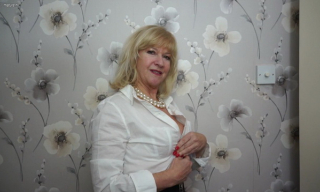 Elegant British mature Emily Jane plays in her white lingerie and black fishnets